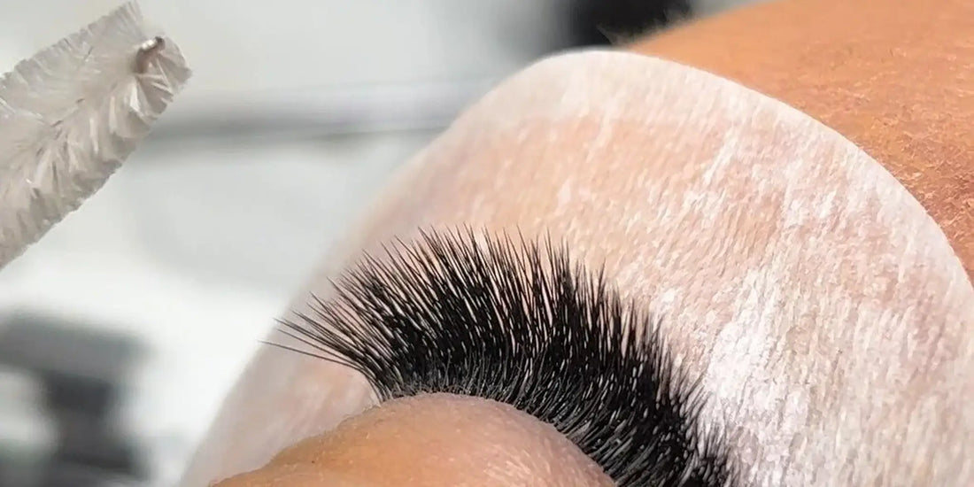 Close-up of freshly applied eyelash extensions on a client, showcasing dense volume lashes and professional application