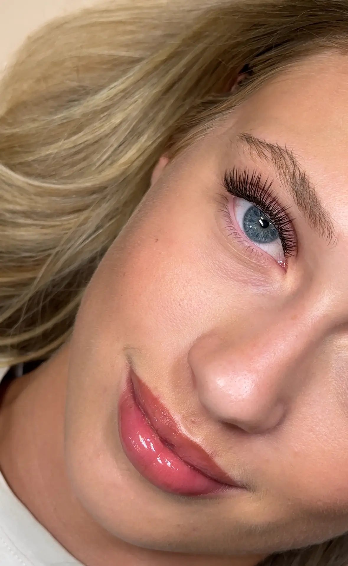 Close-up of a wispy eyelash extension set inspired by the Kim K & Kylie effect on a blonde client.