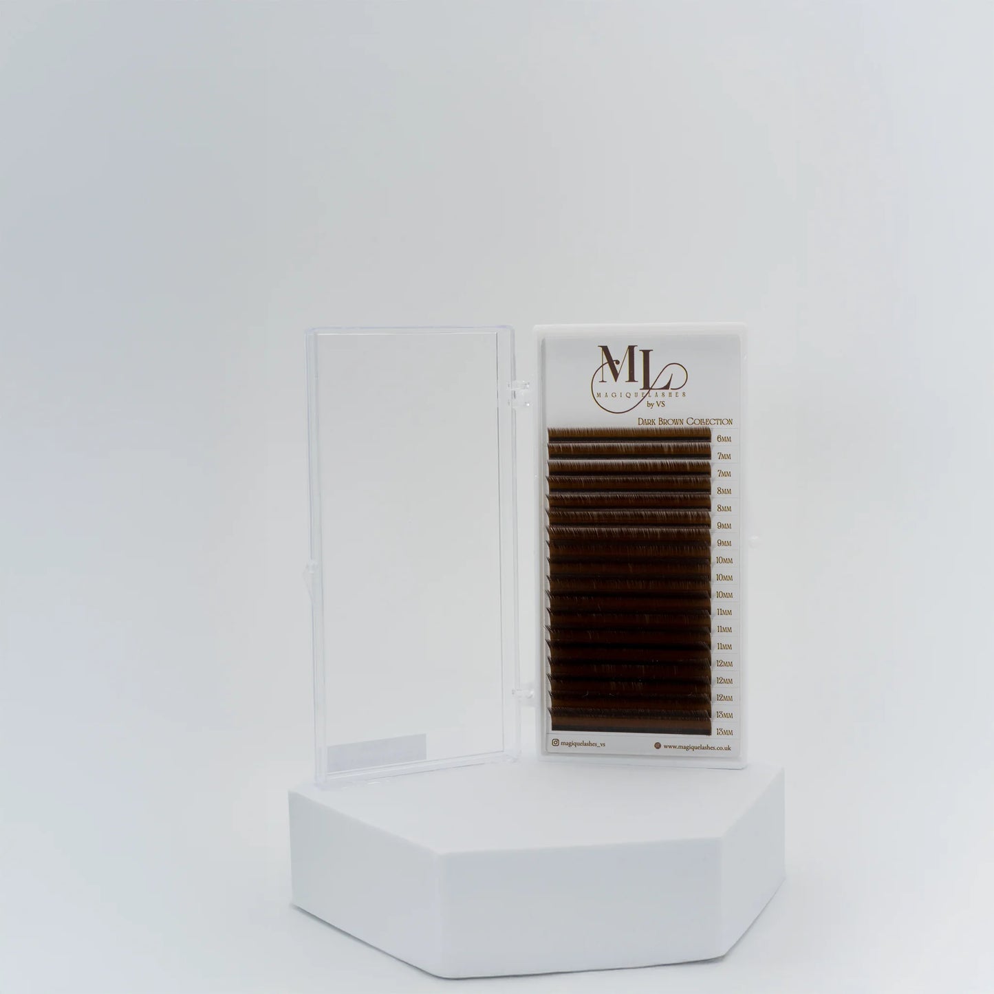 MAGIQUE Pecan brown eyelash extensions tray displayed upright in open case on a white pedestal.