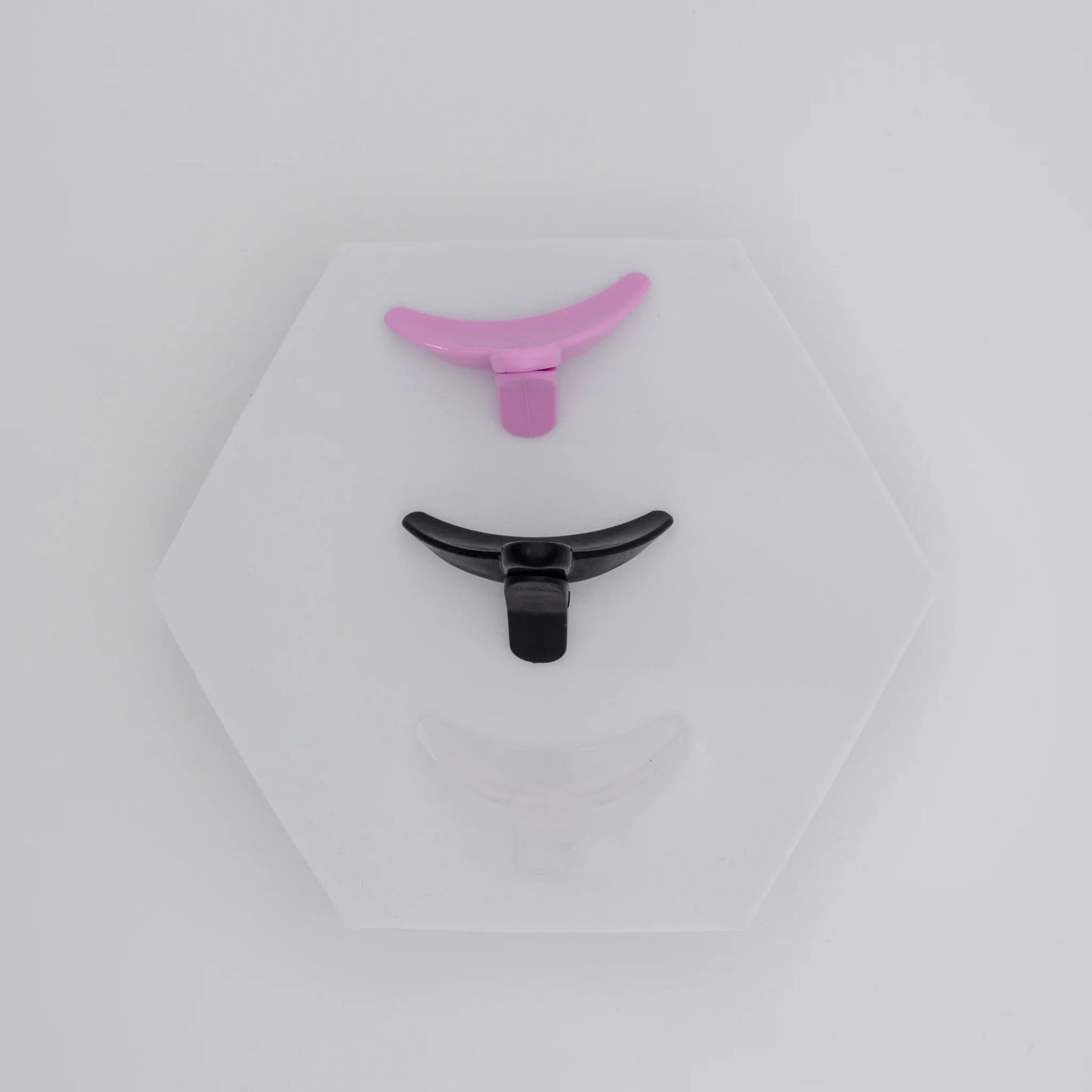 Top view of Reverse Lash Lift Shields by Oshare X Lashmother Uli in clear, black, and purple.