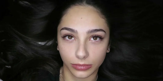 Client wearing brown lash extensions for a soft, natural enhancement