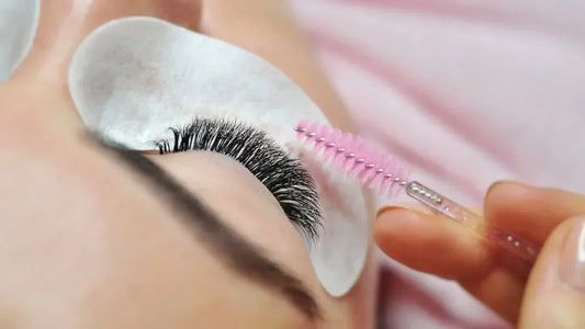 Close-up of brushing lash extensions during aftercare to maintain clean and healthy lashes