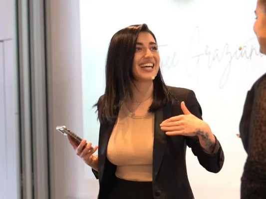 Lash educator announcing Global Lash Forum 2025 giveaway winner on stage