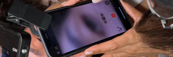 Lash artist recording lash content on phone to grow business during slow months