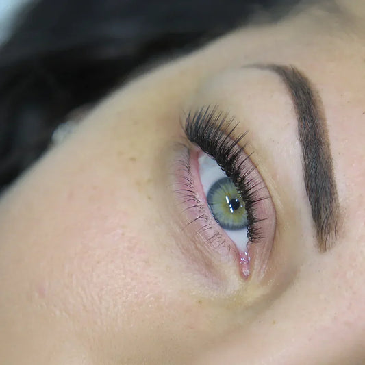 Close view of wet look lashes showing precise lash direction and placement