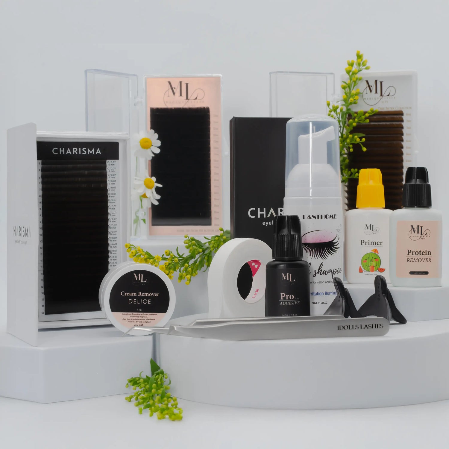 Flat lay of professional eyelash extension supplies including CHARISMA and MAGIQUE lash trays, lash shampoo, primer, glue, removers, and tweezers.