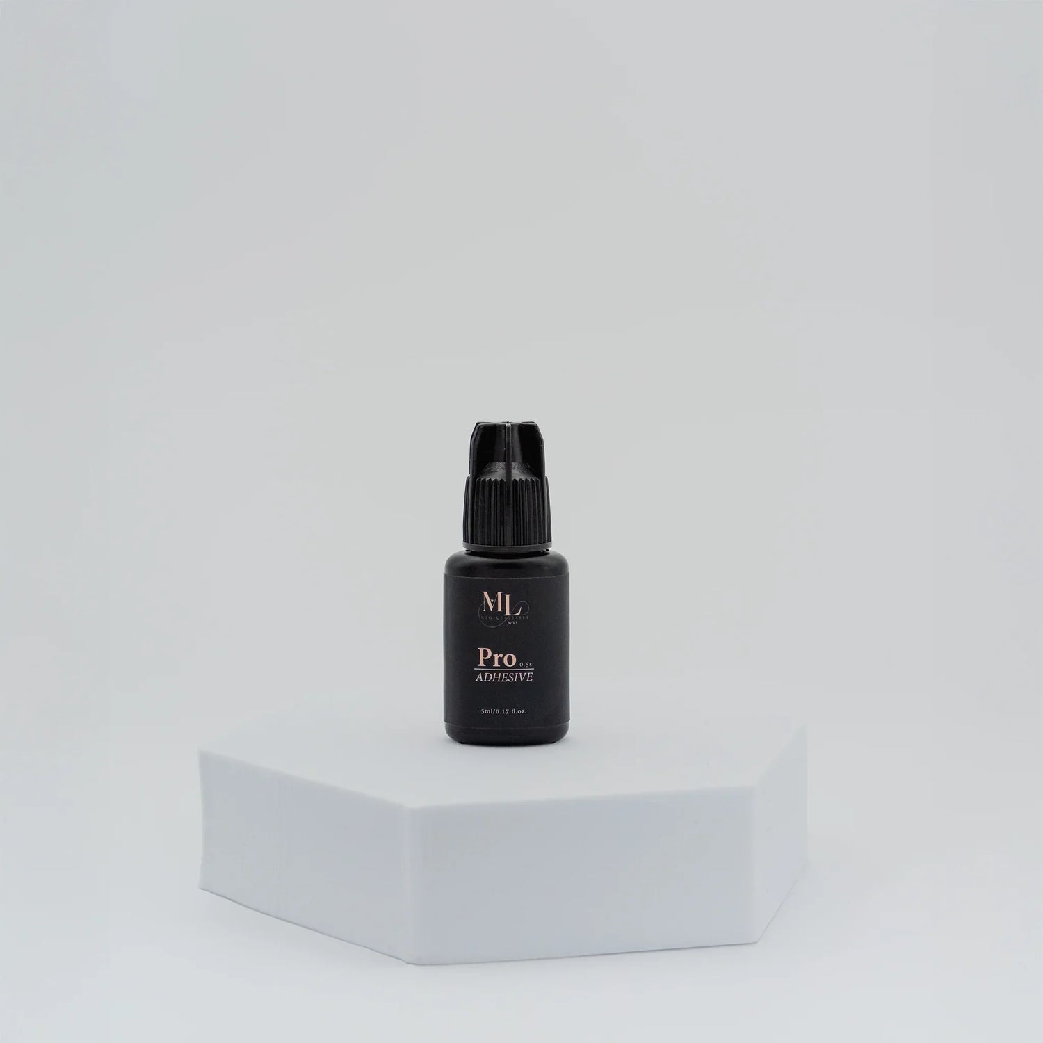 ML Pro Eyelash Extension Glue in black adhesive bottle, displayed on white pedestal for lash professionals.