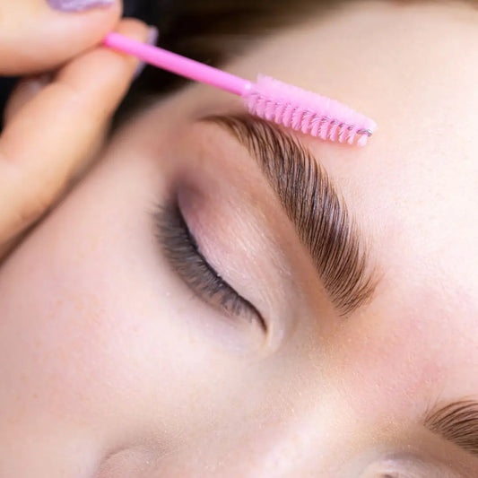 Close-up of brow lamination – lifted, brushed-up brows shaped for a fuller, polished look