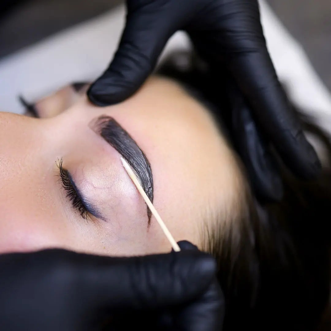 Brow tint and wax in progress – shaping and colour treatment for fuller, defined eyebrows