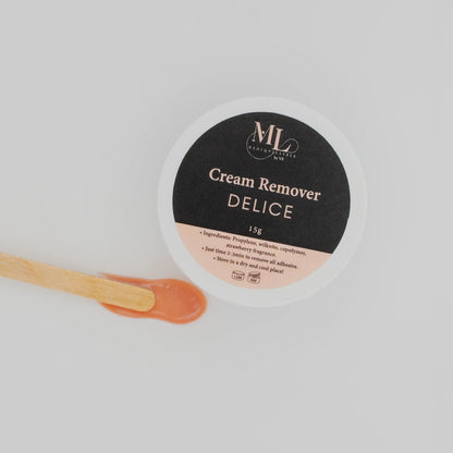 Close-up of Delice cream remover texture with wooden spatula for eyelash extension removal.