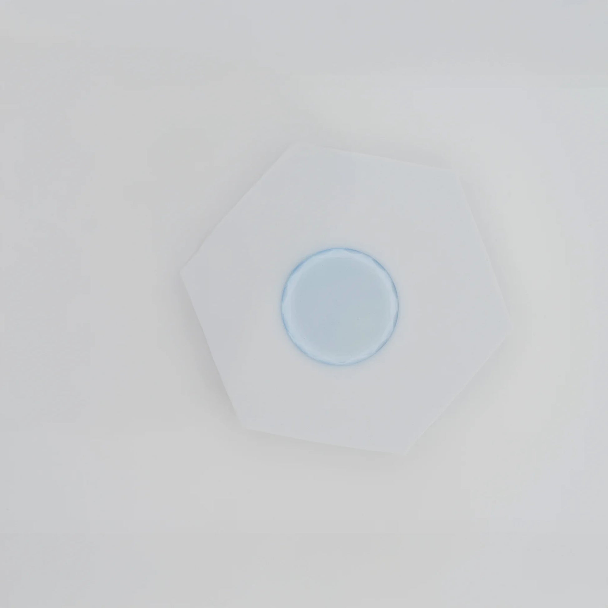 Crystal jade stone for eyelash extensions with adhesive drop, cooling surface preserves glue freshness, essential tool for lash application, The Lash Box Shop.