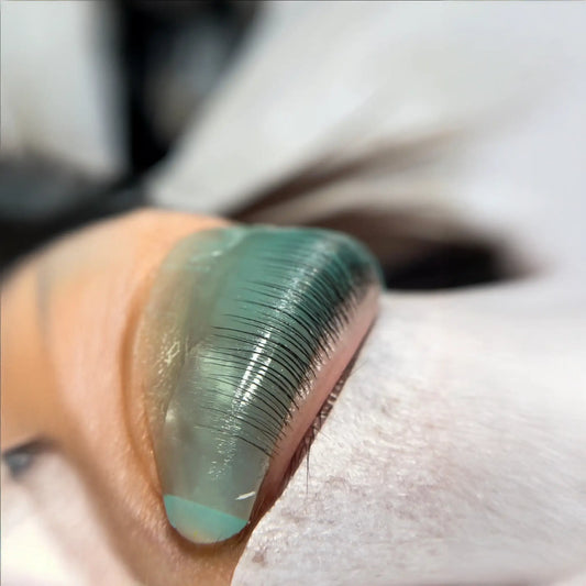Close-up of natural lashes wrapped on a silicone shield during InLei® Lash Filler application, showing precise lift technique