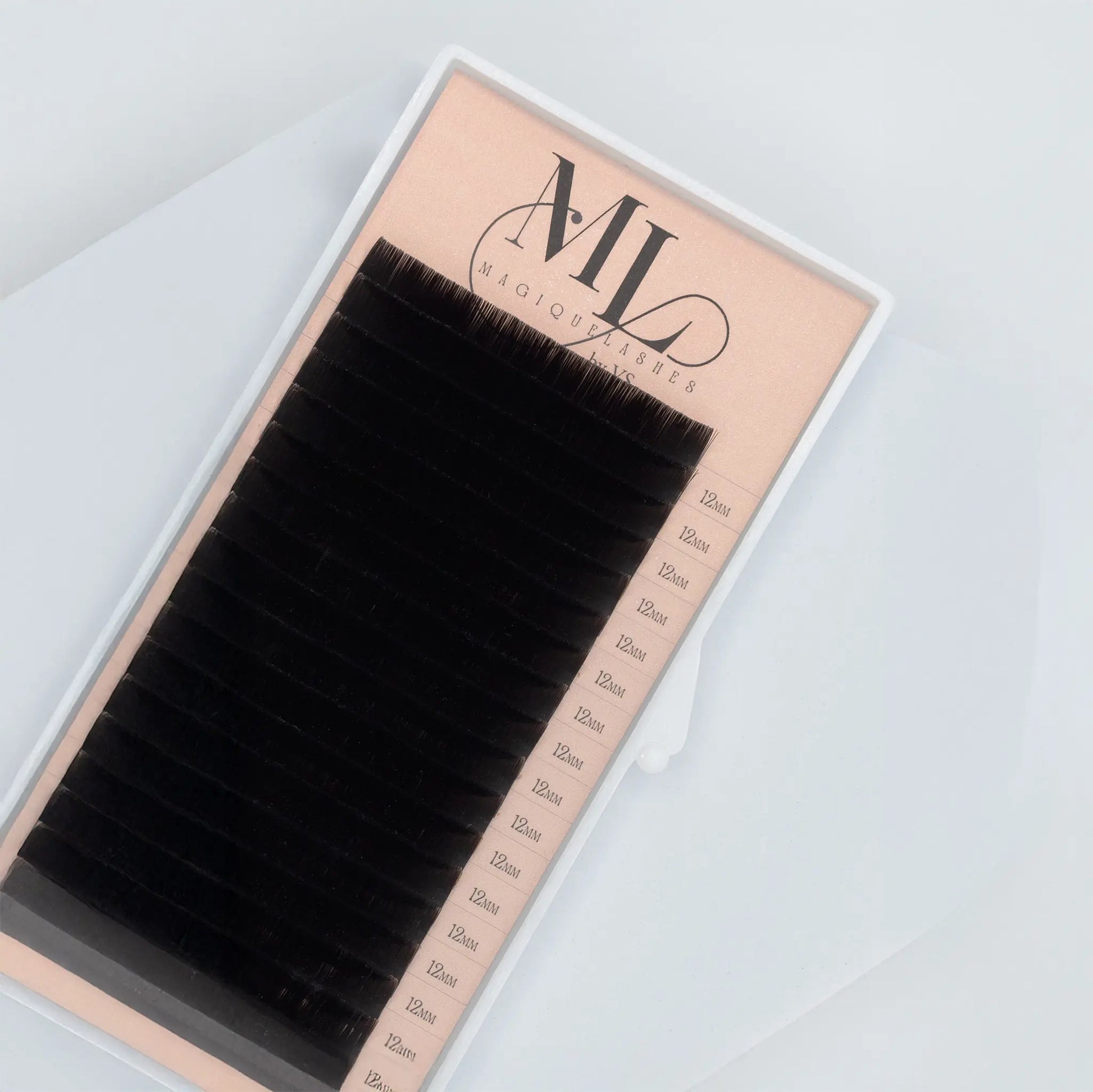 Close-up of MAGIQUE black eyelash extensions tray showing 0.07 faux mink lashes in 12mm length.