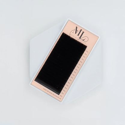 Top view of MAGIQUE black 0.07 eyelash extension tray with uniform lash lengths.