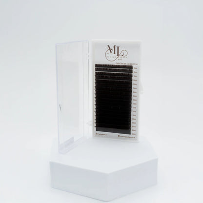 MAGIQUE Espresso brown eyelash extensions tray displayed upright in open case on a white pedestal.