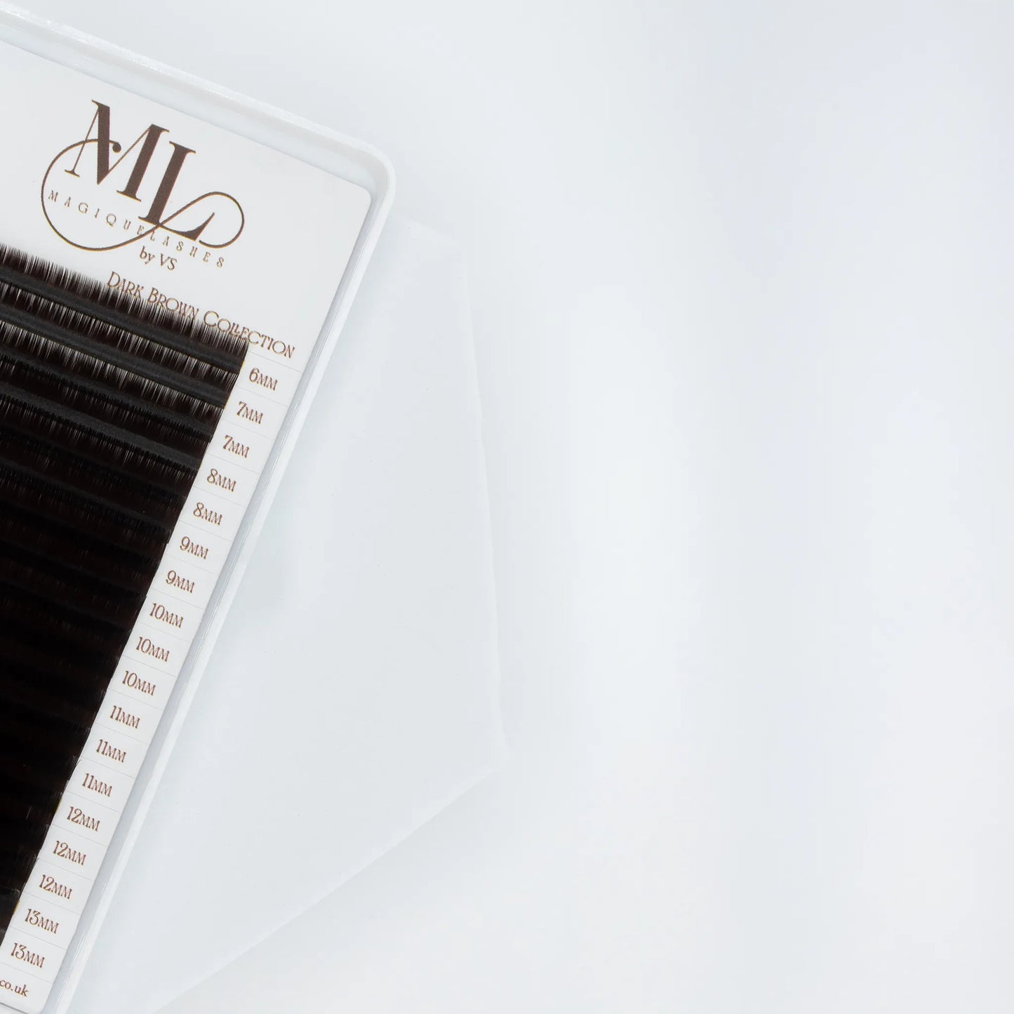 Close-up of MAGIQUE Espresso brown eyelash extensions tray, showing detailed length labels from 6mm to 13mm.