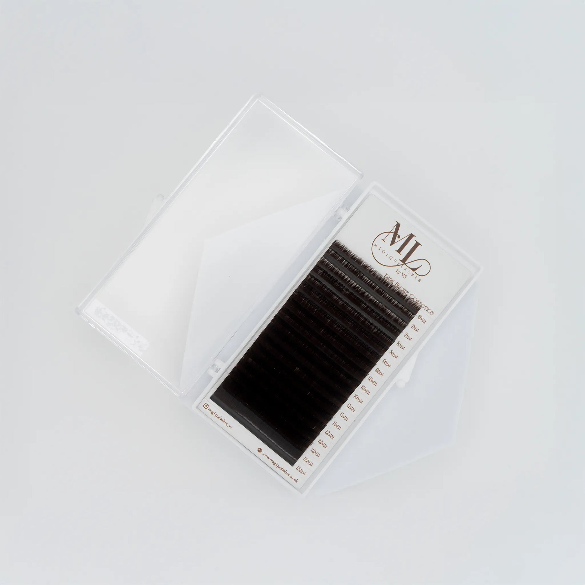 Top view of MAGIQUE Espresso brown lash tray inside open clear case, showing mixed lengths and lash strip labels.