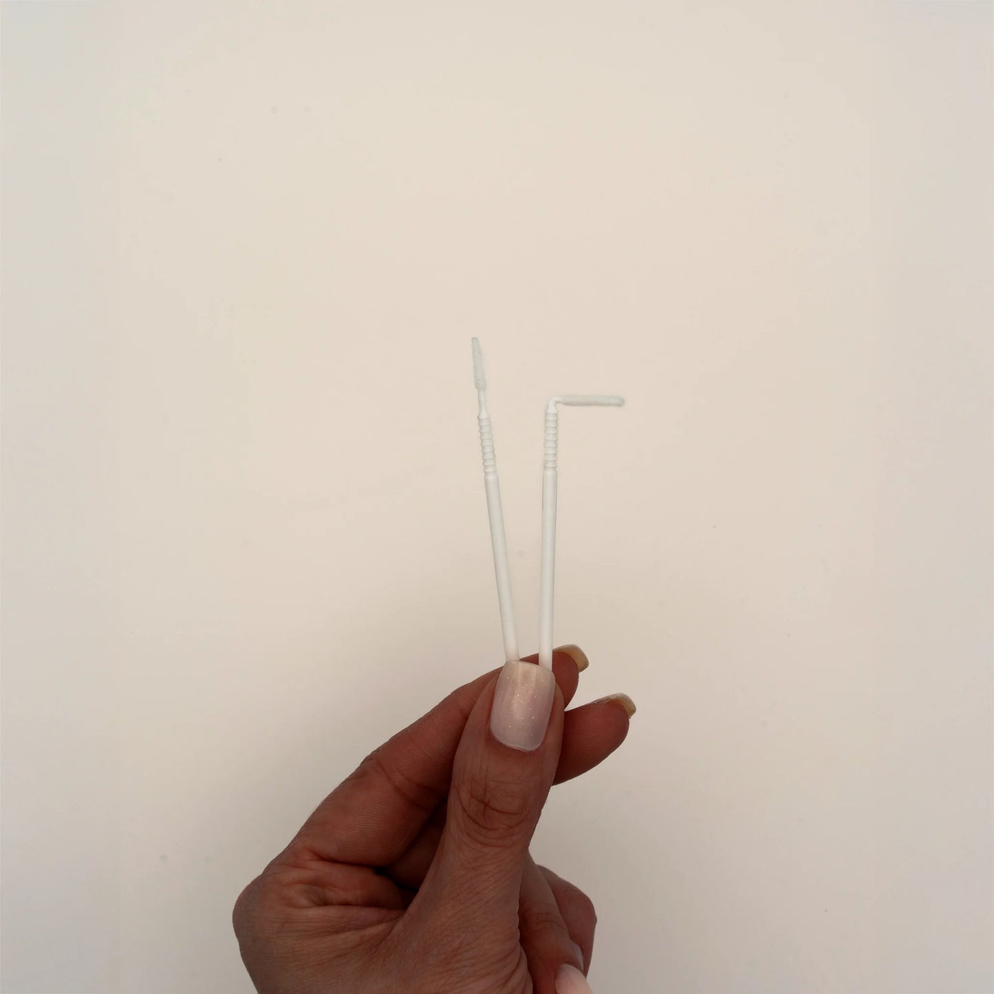 Micro brushes with bendable tip for lash extensions, displayed in hand, ideal for applying cleansers, primers, and removers during lash pre-treatment, The Lash Box Shop.