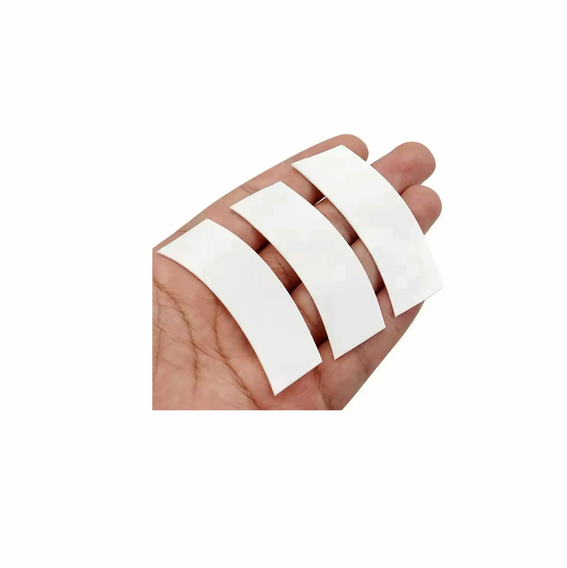 Pre-cut foam tape strips for lash extensions, displayed on hand, ideal for sensitive eyes and secure eyepatch alternative during eyelash extension treatments, The Lash Box Shop.