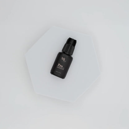 Pro Lash Adhesive for eyelash extensions, fast-drying lash glue displayed on a white hexagon base, ideal for professional lash artists, The Lash Box Shop.